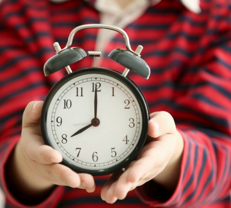 person holding a clock